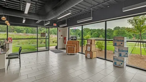Self-storage office with large windows, showcasing packing supplies.